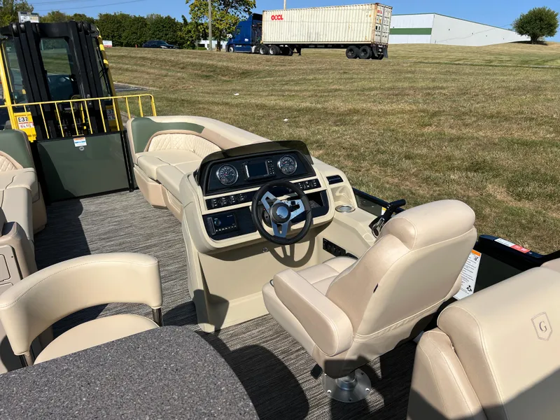Slide: The Image of 2025 Godfrey SWEETWATER 2286 MT pontoon boat interior with beige seating and modern dashboard. - 19
