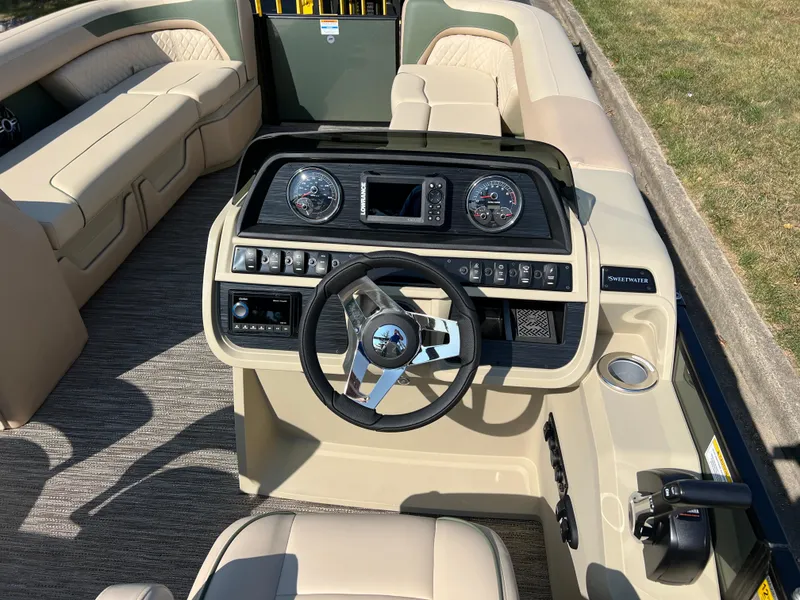 Slide: The Image of 2025 Godfrey SWEETWATER 2286 MT boat interior with steering wheel and dashboard controls. - 20