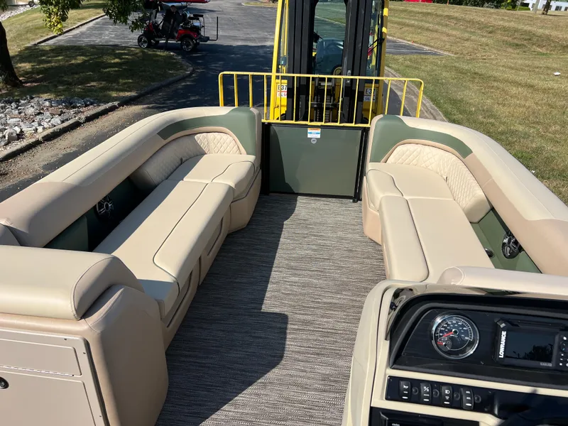 Slide: The Image of 2025 Godfrey SWEETWATER 2286 MT pontoon boat interior with beige seating and dashboard. - 25