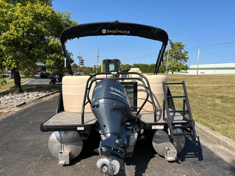 Slide: The Image of 2025 Godfrey SWEETWATER 2286 MT pontoon boat with Yamaha engine, parked outdoors. - 3