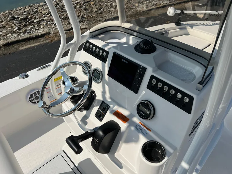 Slide: The Image of 2025 Robalo 206 Cayman boat dashboard with steering wheel and control panel. - 12