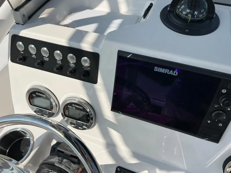 Slide: The Image of Dashboard of 2025 Robalo 206 Cayman boat with Simrad display and controls. - 13