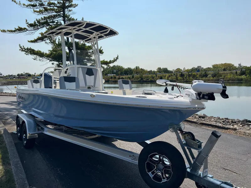 Slide: The Image of 2025 Robalo 206 Cayman boat on trailer by a scenic lake. - 3