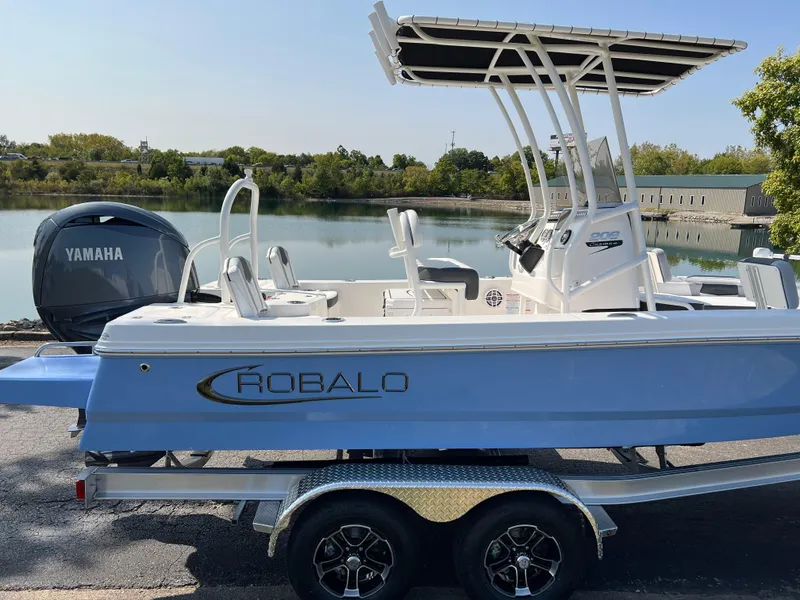 Slide: The Image of 2025 Robalo 206 Cayman boat with Yamaha engine by a serene lake. - 4