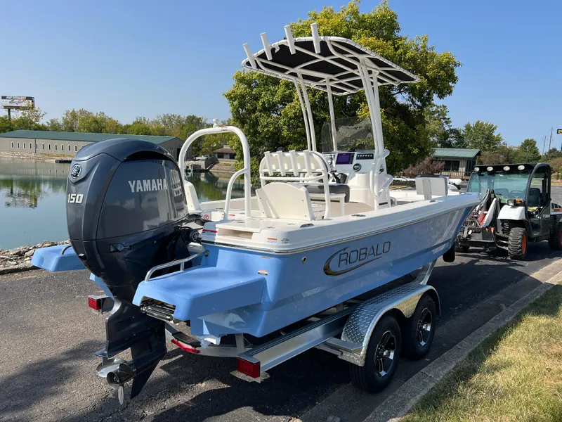 Slide: The Image of 2025 Robalo 206 Cayman boat with Yamaha engine on trailer by a lake. - 5