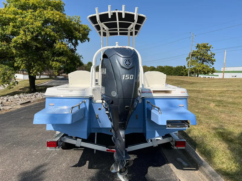 Slide: The Image of 2025 Robalo 206 Cayman boat with Yamaha 150 engine, parked outdoors. - 6