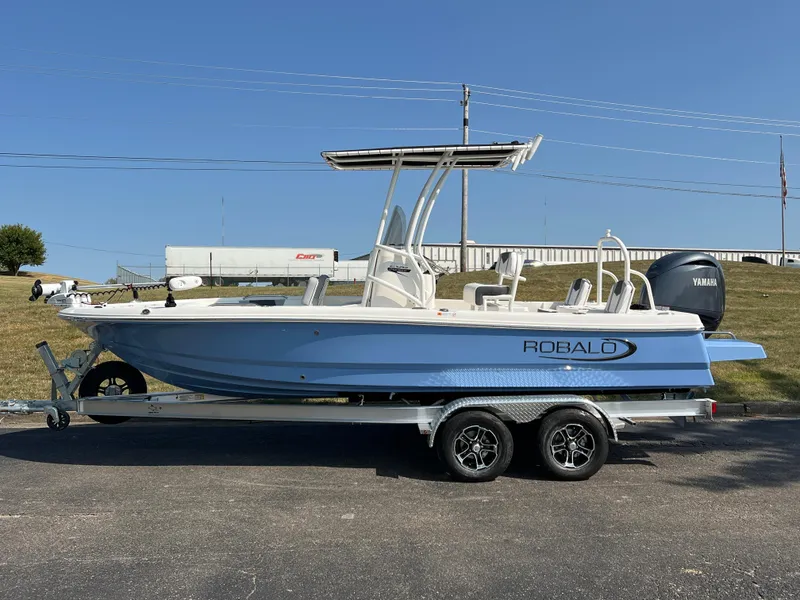 Slide: The Image of 2025 Robalo 206 Cayman boat on trailer, side view, clear sky background. - 8