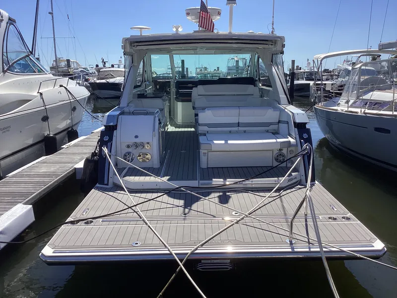 Slide: The Image of 2020 Formula 380 Super Sport Crossover yacht docked at marina, rear view. - 1