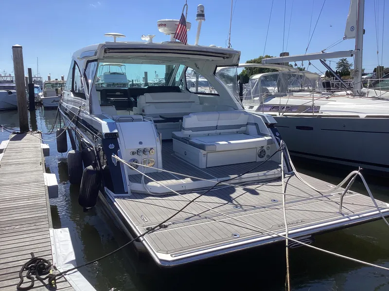Slide: The Image of 2020 Formula 380 Super Sport Crossover yacht docked at marina, rear view. - 2