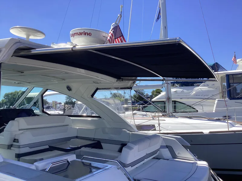 Slide: The Image of 2020 Formula 380 Super Sport Crossover yacht with sunshade, docked in marina. - 29