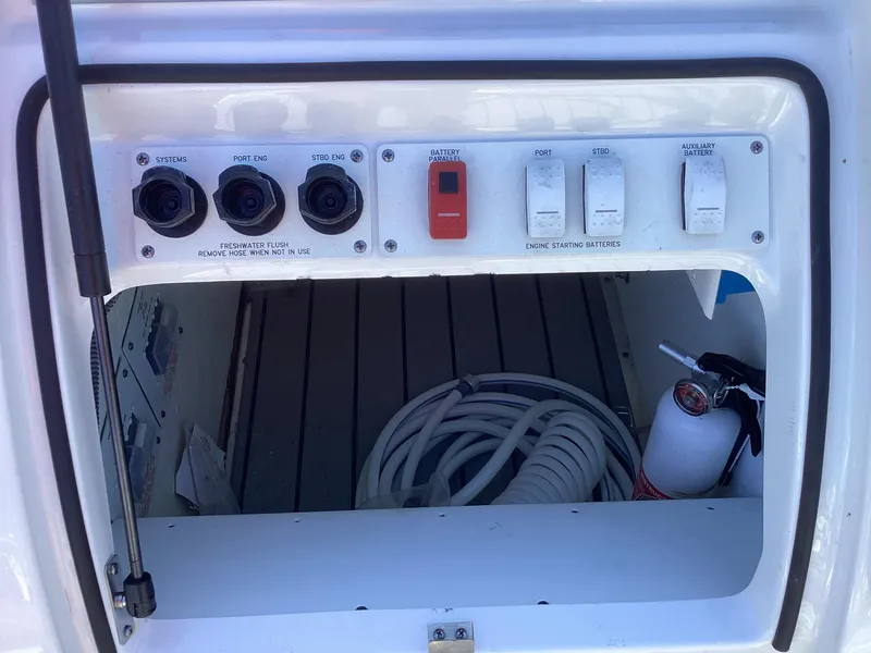 Slide: The Image of 2020 Formula 380 Super Sport Crossover control panel with switches and coiled hose. - 32