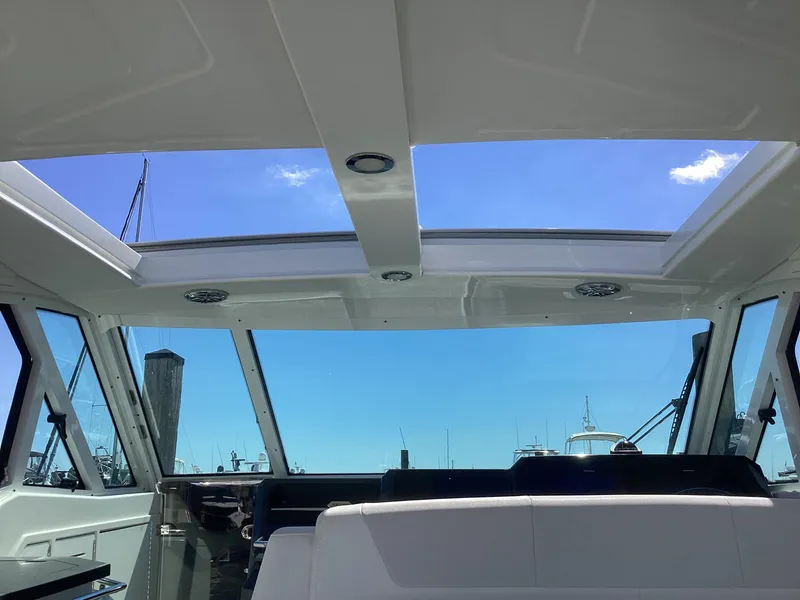 Slide: The Image of Interior view of 2020 Formula 380 Super Sport Crossover boat with skylight and blue sky. - 34