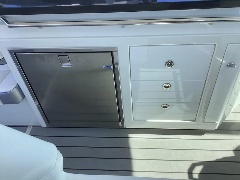 Slide: The Image of 2020 Formula 380 Super Sport Crossover boat interior with stainless steel fridge and storage drawers. - 36