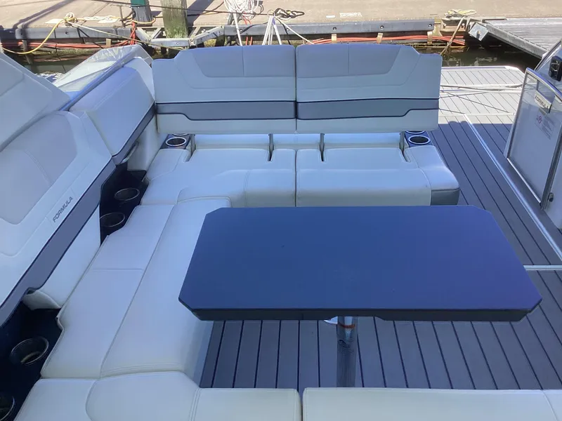 Slide: The Image of 2020 Formula 380 Super Sport Crossover boat interior with seating and table. - 43