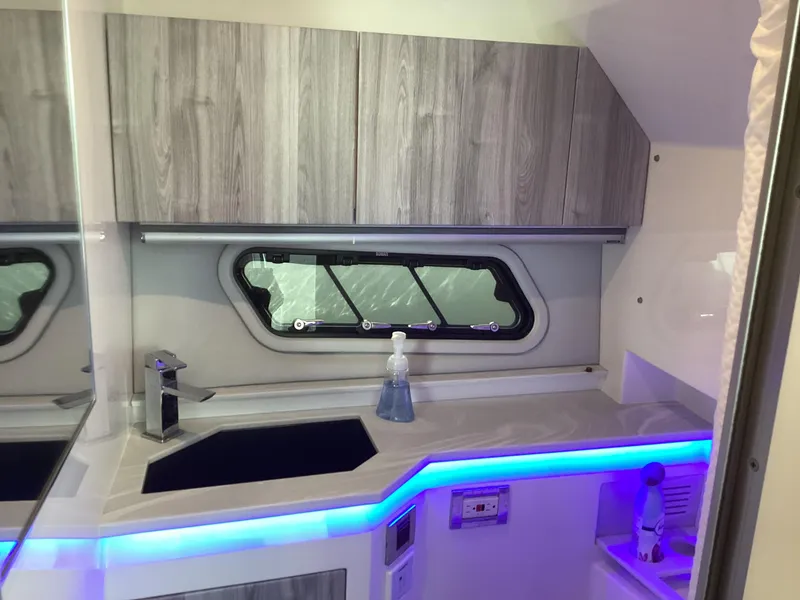 Slide: The Image of 2020 Formula 380 Super Sport Crossover interior with modern kitchenette and ambient lighting. - 45