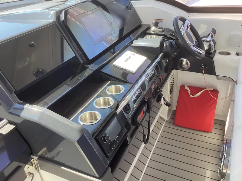 Slide: The Image of 2020 Formula 380 Super Sport Crossover cockpit with modern controls and cup holders. - 5