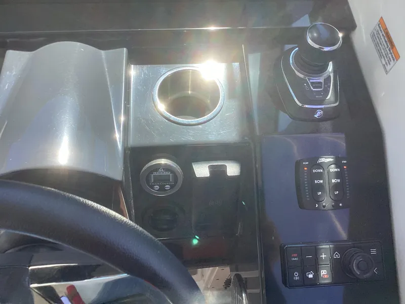 Slide: The Image of Control panel of a 2020 Formula 380 Super Sport Crossover boat with cup holder and joystick. - 6