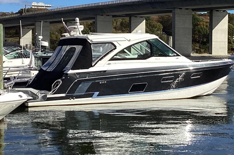 Slide: The Image of 2020 Formula 380 Super Sport Crossover I/O boat docked near a bridge. - 81