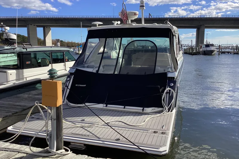 Slide: The Image of 2020 Formula 380 Super Sport Crossover I/O docked at marina under bridge. - 82