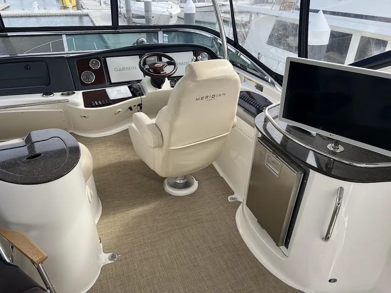 Slide: The Image of Interior of 2012 Meridian 441 Sedan yacht with helm, seating, and electronics. - 11