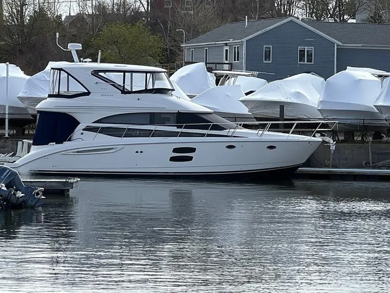 Slide: The Image of 2012 Meridian 441 Sedan yacht docked at marina, surrounded by covered boats. - 13