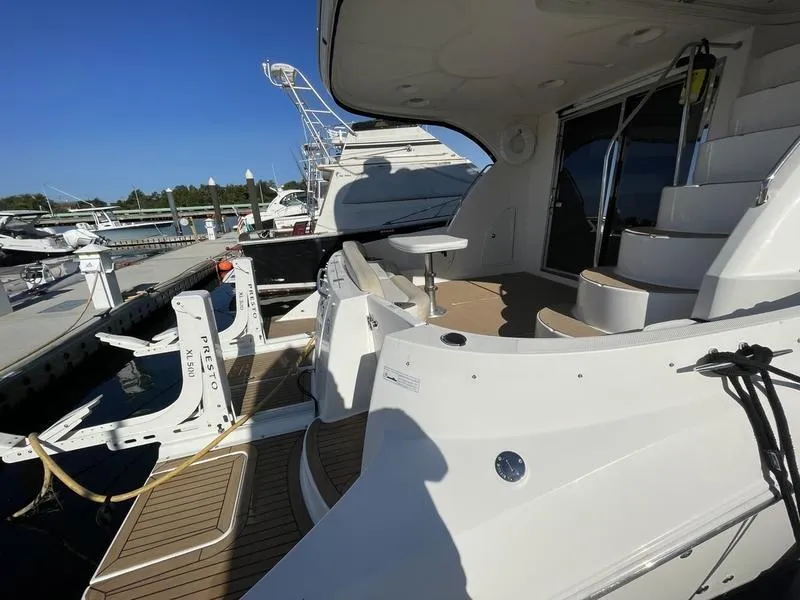 Slide: The Image of 2012 Meridian 441 Sedan yacht docked, featuring spacious deck and modern design. - 19