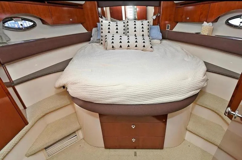 Slide: The Image of Luxurious 2012 Meridian 441 Sedan yacht bedroom with cozy bed and elegant wood finish. - 26