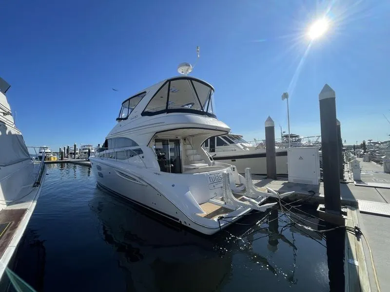 Slide: The Image of 2012 Meridian 441 Sedan yacht docked at marina under clear blue sky. - 28