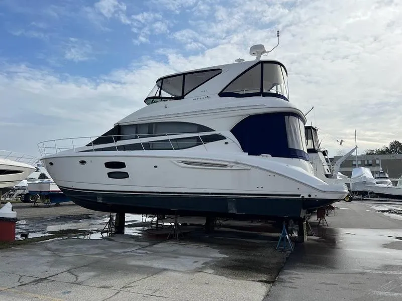 Slide: The Image of 2012 Meridian 441 Sedan yacht on dry dock under a cloudy sky. - 3