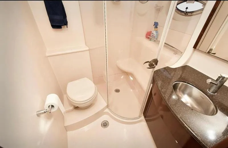 Slide: The Image of 2012 Meridian 441 Sedan yacht bathroom with shower, toilet, and sink. - 36