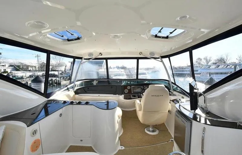 Slide: The Image of Interior of 2012 Meridian 441 Sedan yacht with panoramic windows and modern helm. - 37