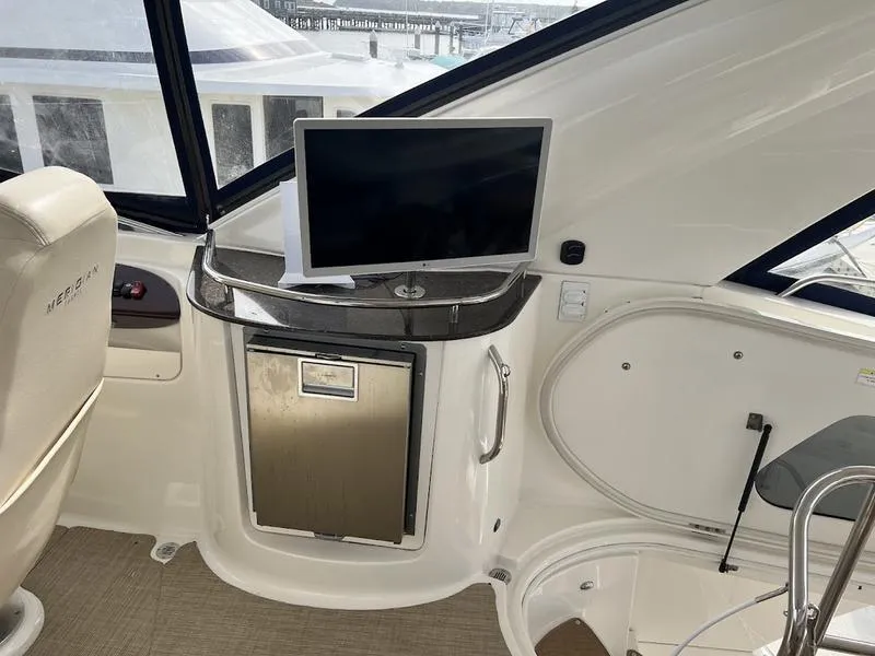 Slide: The Image of 2012 Meridian 441 Sedan yacht interior with TV and mini fridge. - 38