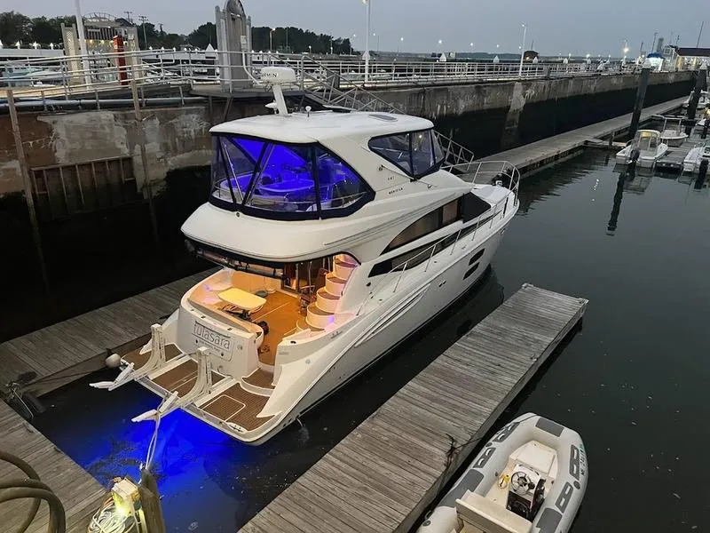 Slide: The Image of 2012 Meridian 441 Sedan yacht docked at marina with blue lights. - 40