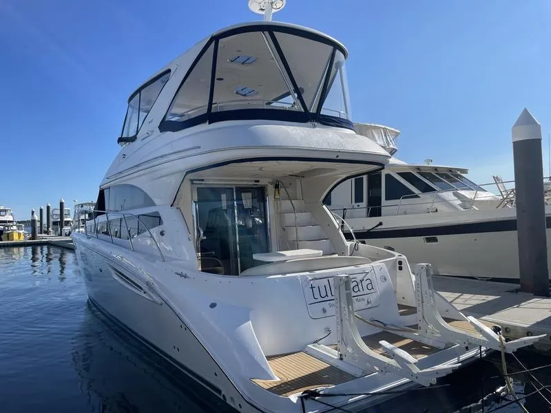 Slide: The Image of 2012 Meridian 441 Sedan yacht docked at marina under clear blue sky. - 45