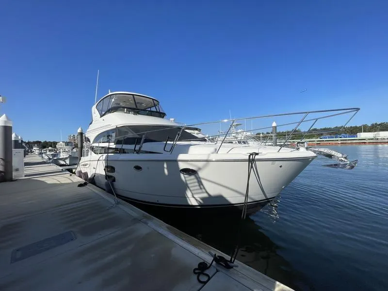 Slide: The Image of 2012 Meridian 441 Sedan yacht docked at marina under clear blue sky. - 49