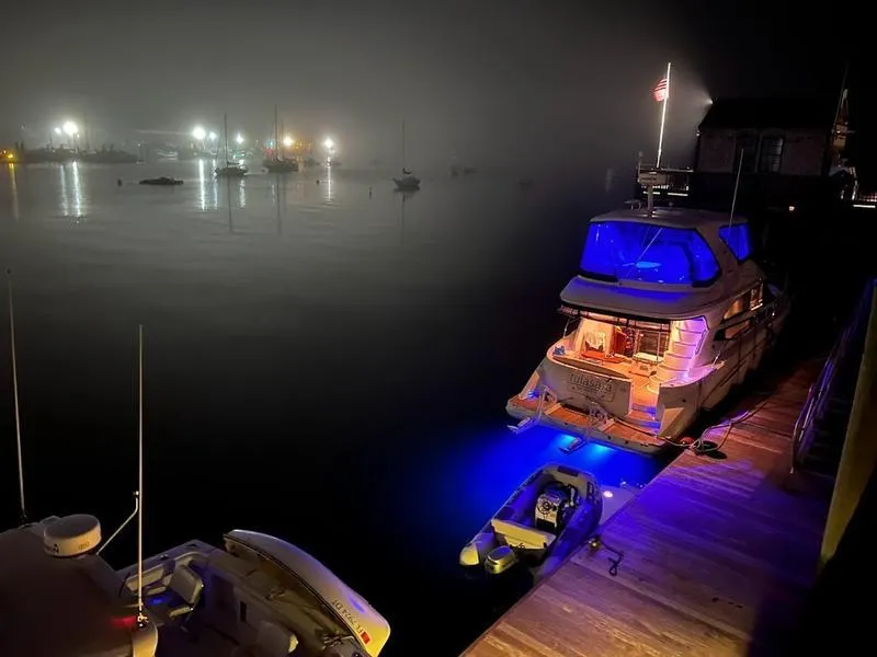 Slide: The Image of Meridian 441 Sedan 2012 yacht docked at night with illuminated blue lights. - 5