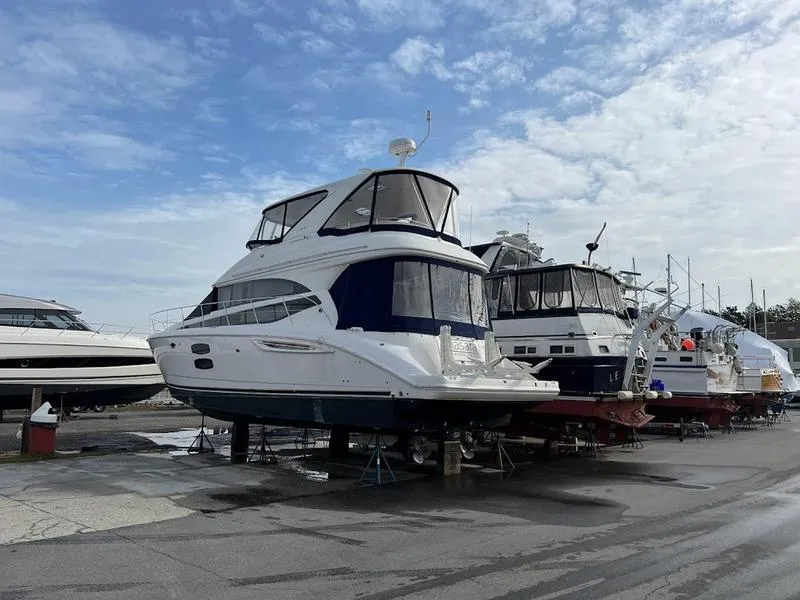 Slide: The Image of 2012 Meridian 441 Sedan yacht on dry dock under a cloudy sky. - 6