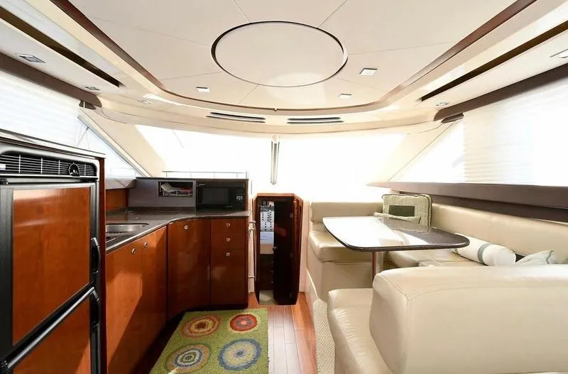 Slide: The Image of Luxurious interior of 2012 Meridian 441 Sedan yacht with modern kitchen and dining area. - 9