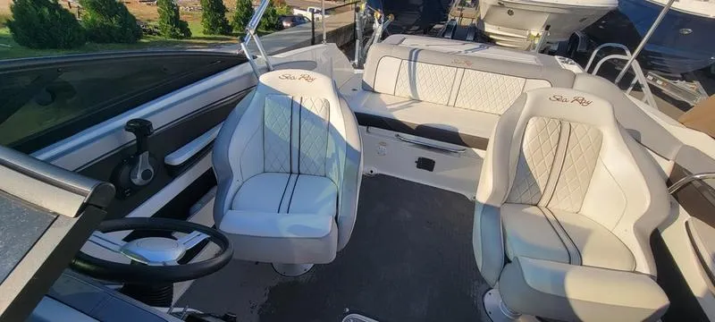 Slide: The Image of 2017 Sea Ray 220 SD boat interior with white seating and steering wheel. - 11