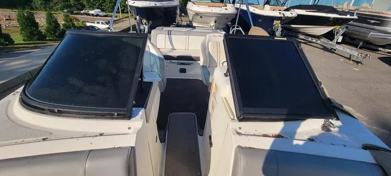 Slide: The Image of 2017 Sea Ray 220 SD boat with dual windshields, docked among other boats. - 12