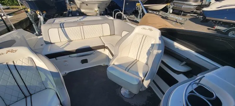 Slide: The Image of 2017 Sea Ray 220 SD boat interior with white seating and modern design. - 13