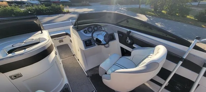 Slide: The Image of 2017 Sea Ray 220 SD boat interior with steering wheel and seating. - 16