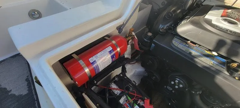 Slide: The Image of Engine compartment of 2017 Sea Ray 220 SD with fire extinguisher and battery. - 17