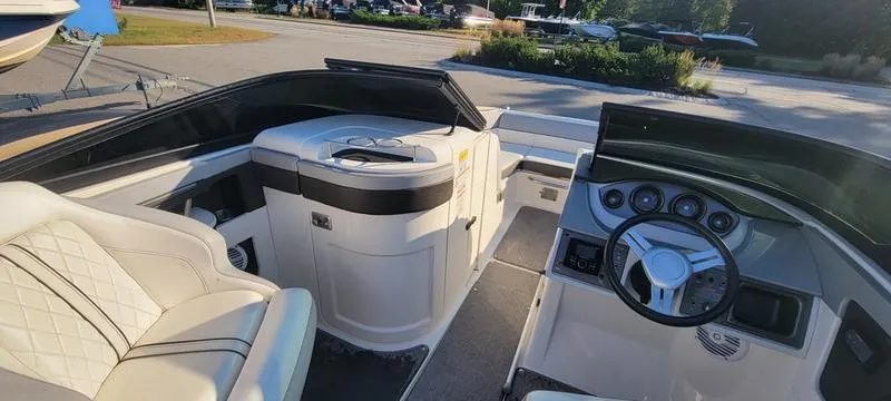 Slide: The Image of 2017 Sea Ray 220 SD boat interior with steering wheel and seating. - 18