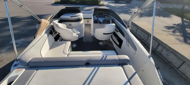 Slide: The Image of 2017 Sea Ray 220 SD boat interior with white seating and steering console. - 21