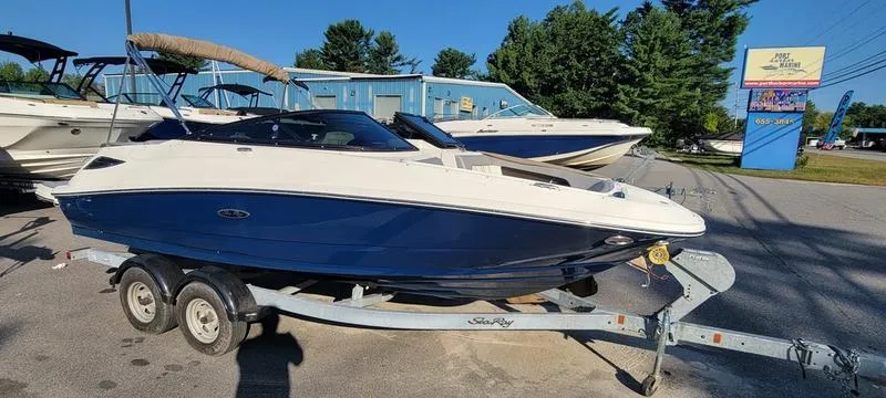 Slide: The Image of 2017 Sea Ray 220 SD boat on trailer, parked outdoors. - 25