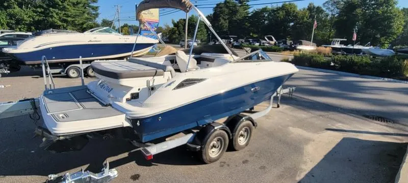 Slide: The Image of 2017 Sea Ray 220 SD boat on trailer in sunny outdoor setting. - 26