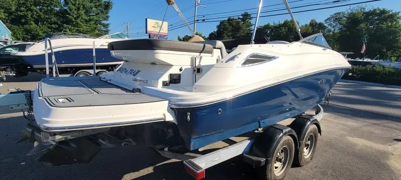 Slide: The Image of 2017 Sea Ray 220 SD boat on trailer, blue and white exterior. - 27