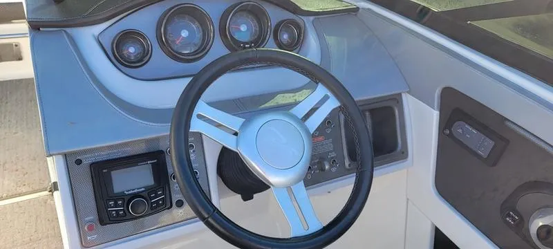 Slide: The Image of 2017 Sea Ray 220 SD boat dashboard with steering wheel and gauges. - 5