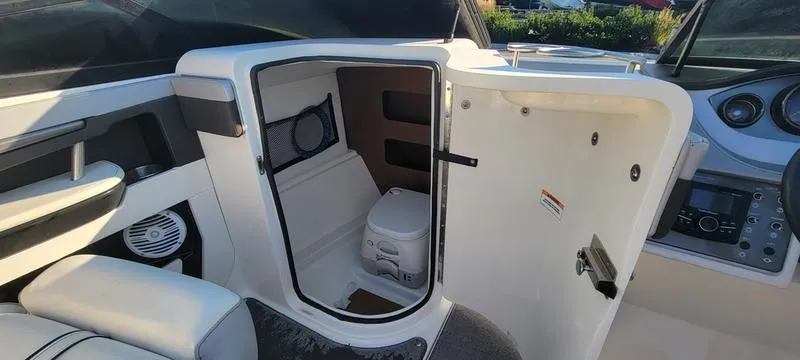 Slide: The Image of 2017 Sea Ray 220 SD boat interior with open storage compartment and seating. - 9